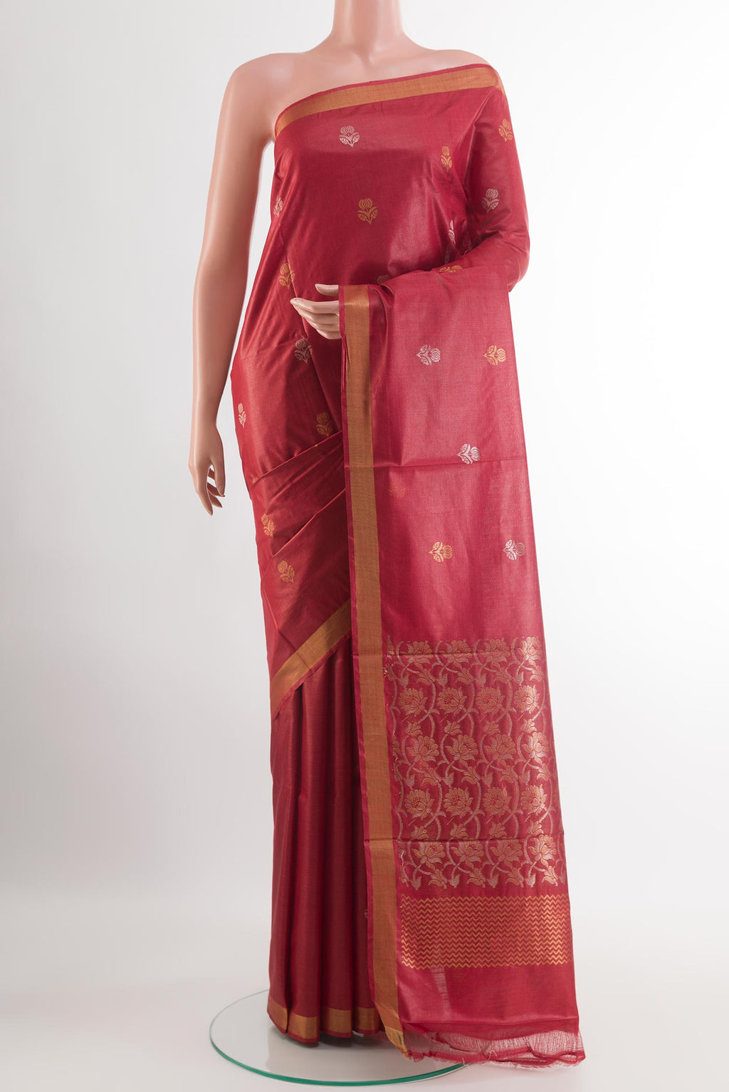 Maroon Tussar Silk Saree with Zari Butta on the body and Zari Border.  displayed on a mannequin