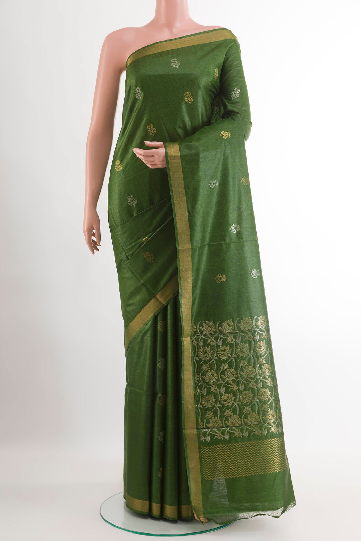 Green Tussar Silk Saree with Zari Butta on the body and Zari Border.  displayed on a mannequin