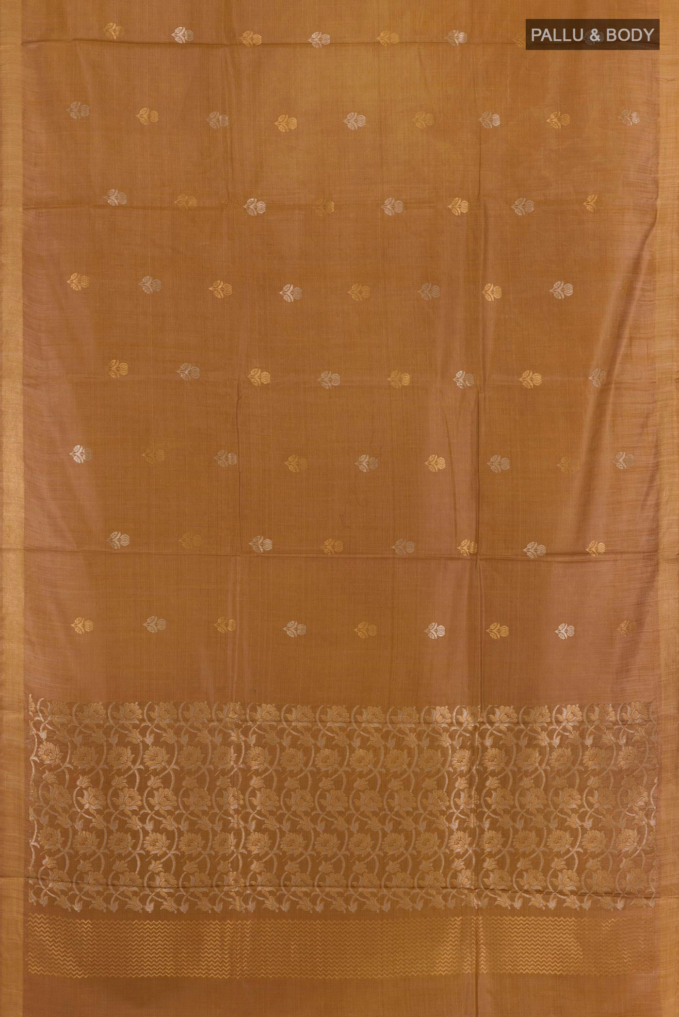 Flat view of Dark Beige Tussar Silk Saree with Zari Butta on the body and Zari Border. 