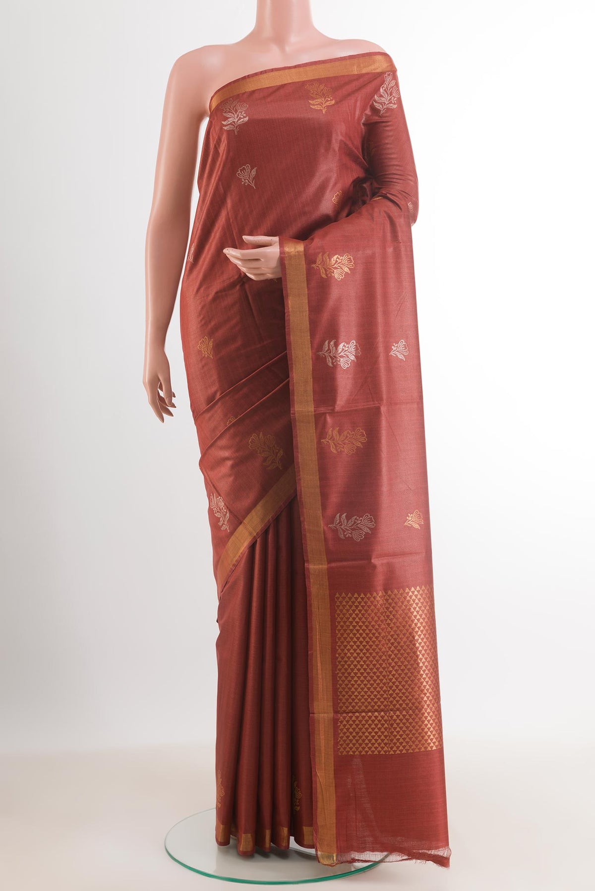 Maroon Tussar Silk Saree with Zari Butta on the body and Zari Border.  displayed on a mannequin