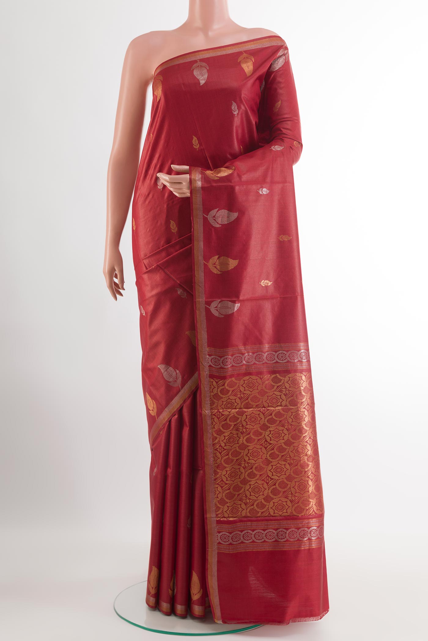 Red Tussar Silk Saree with Zari Butta on the body and Zari Border.  displayed on a mannequin
