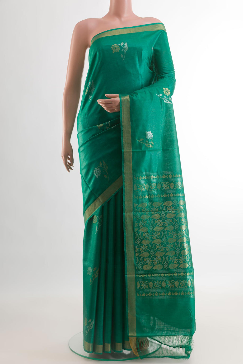 Green Tussar Silk Saree with Zari Butta on the body and Zari Border.  displayed on a mannequin