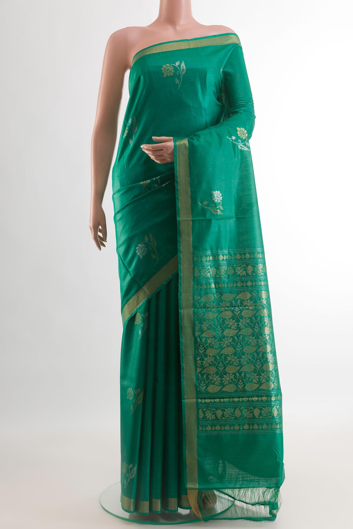 Green Tussar Silk Saree with Zari Butta on the body and Zari Border.  displayed on a mannequin