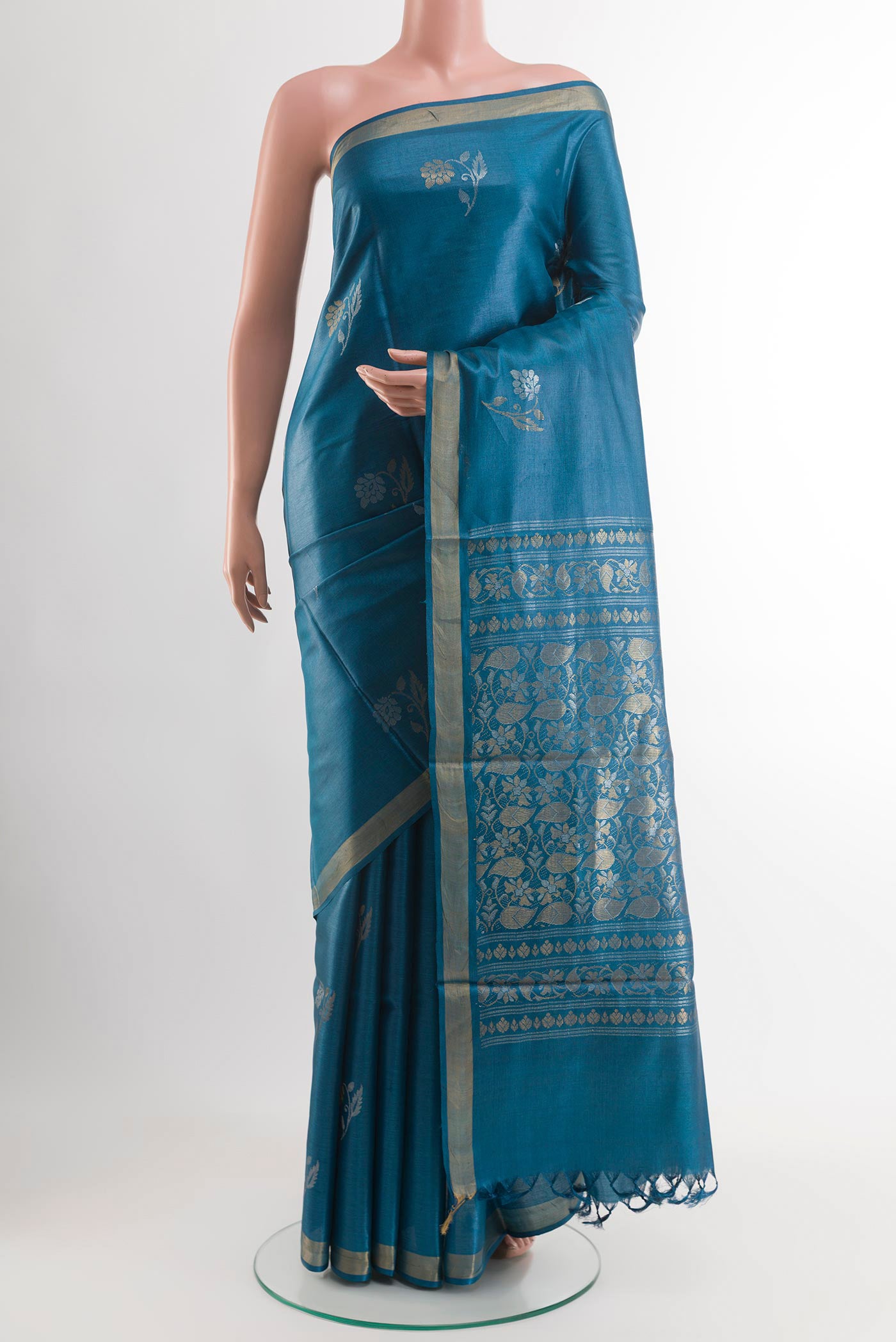 Blue Tussar Saree with Zari Butta on the body and Zari Border.  displayed on a mannequin