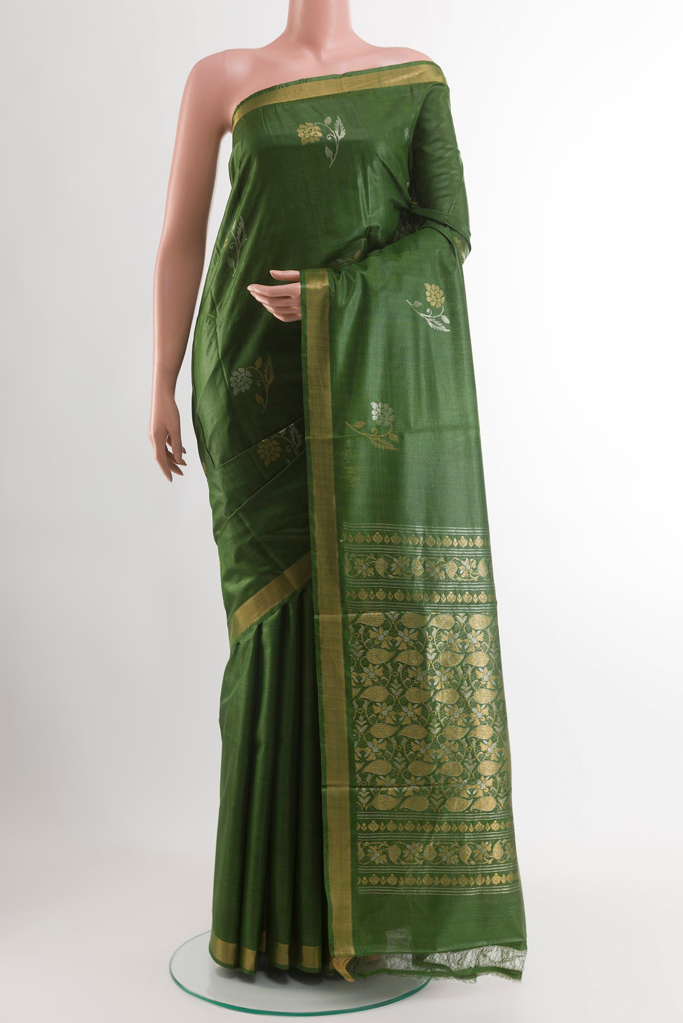 Green Tussar Saree with Zari Butta on the body and Zari Border.  displayed on a mannequin