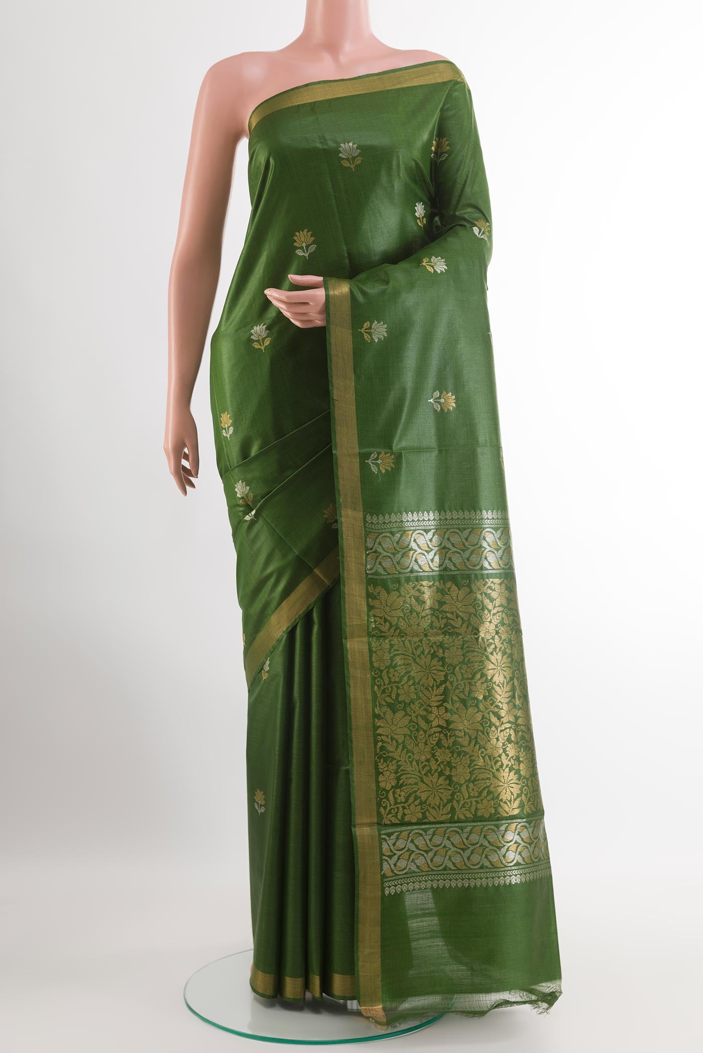 Green Tussar Silk Saree with Zari Butta on the body and Zari Border.  displayed on a mannequin
