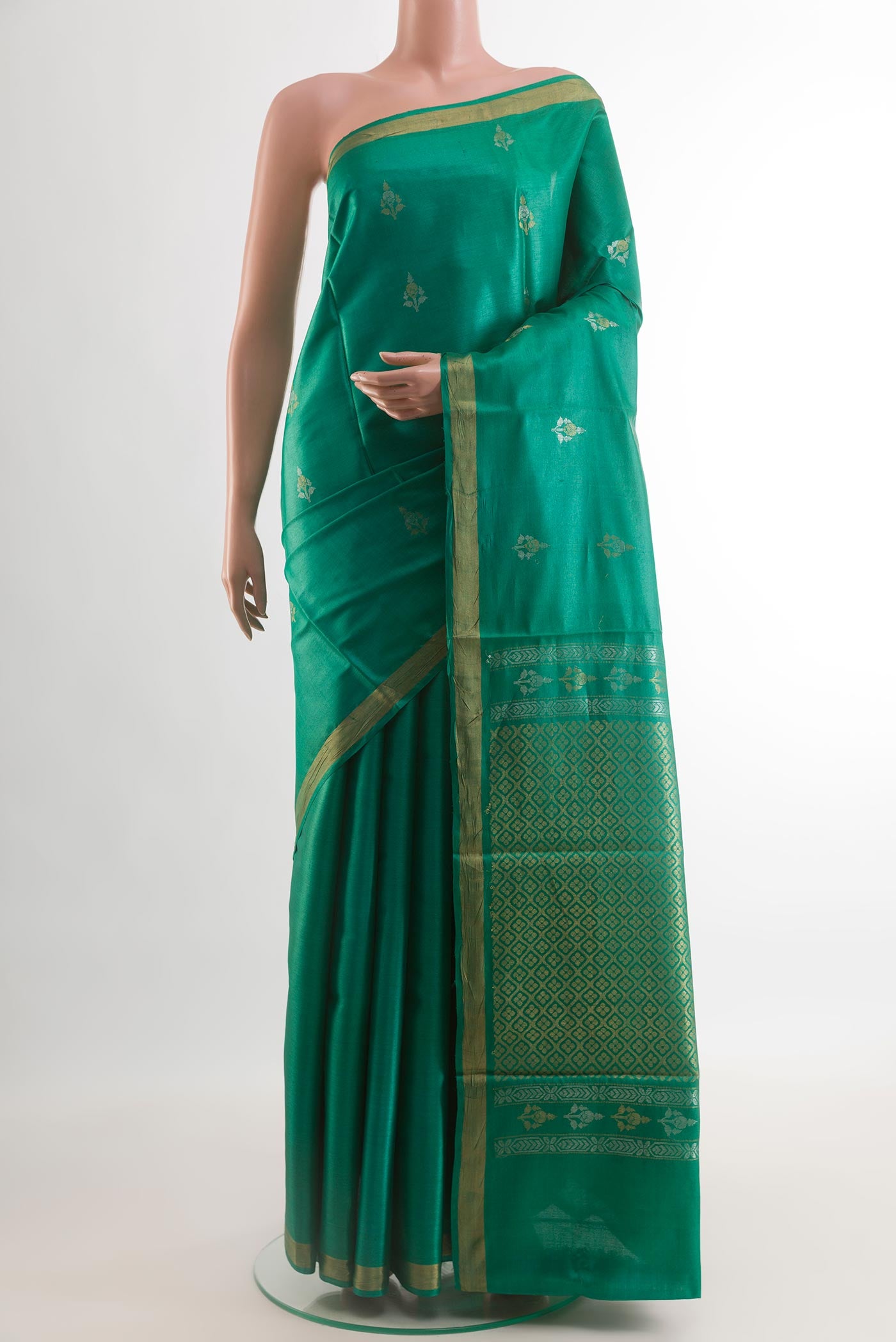 Green Tussar Silk Saree with Zari Butta on the body and Zari Border.  displayed on a mannequin