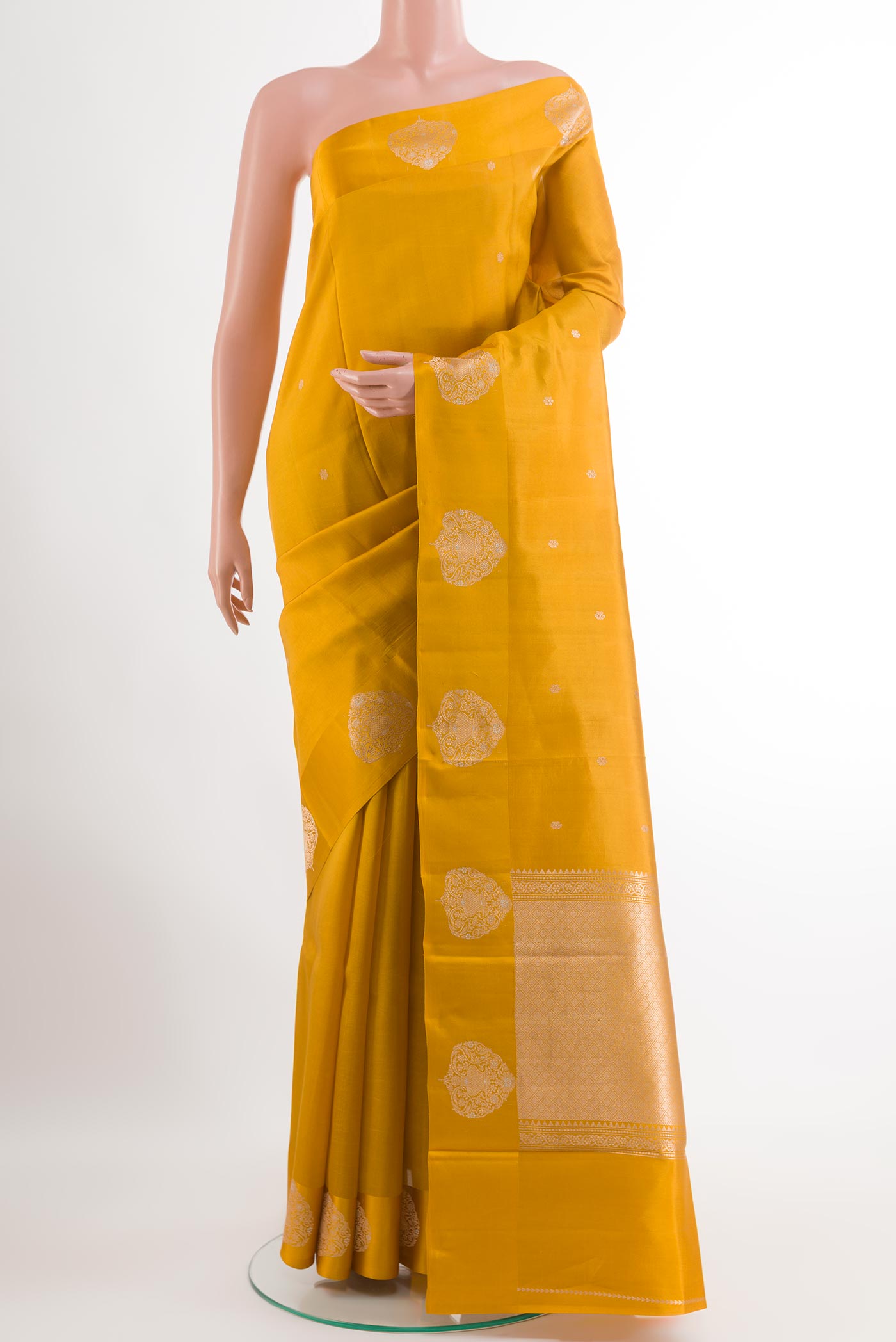 Yellow Tussar Silk Saree with Zari Butta on the body and Zari Border.  displayed on a mannequin