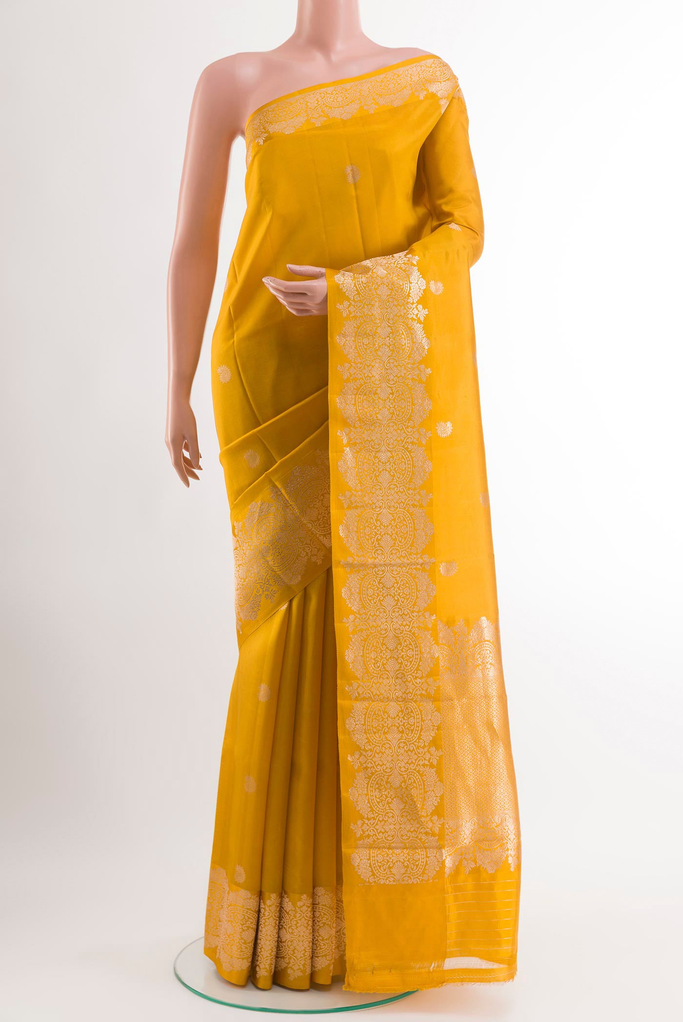Yellow Banarasi Katan Silk Saree with Zari Butta on the body and Zari Border.  displayed on a mannequin
