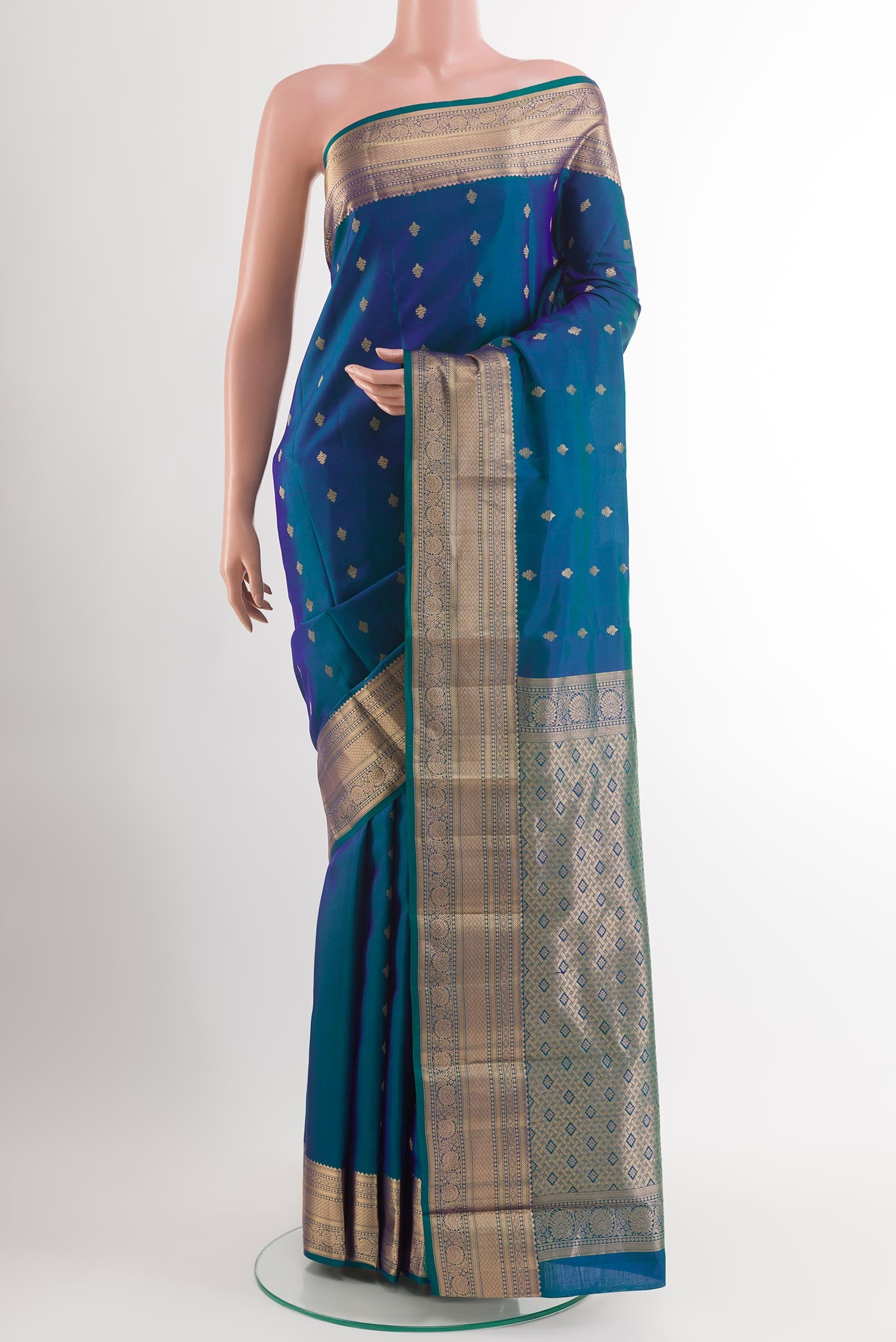 Peacock Blue Kanchipuram Silk Saree with Zari Butta on the body and Zari Border.  displayed on a mannequin