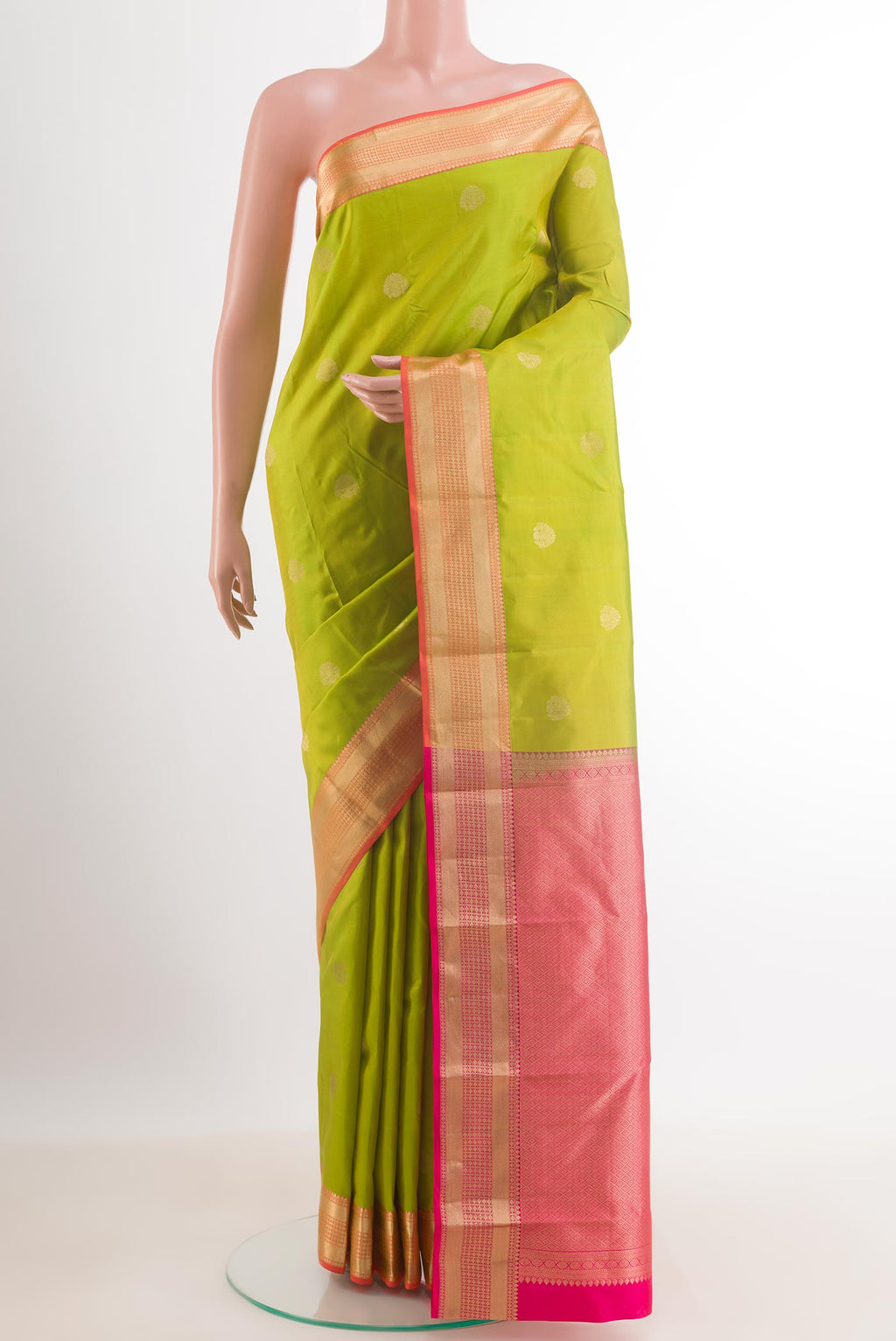 Green Kanchipuram Silk Saree with Zari Butta on the body and Zari Border.  displayed on a mannequin