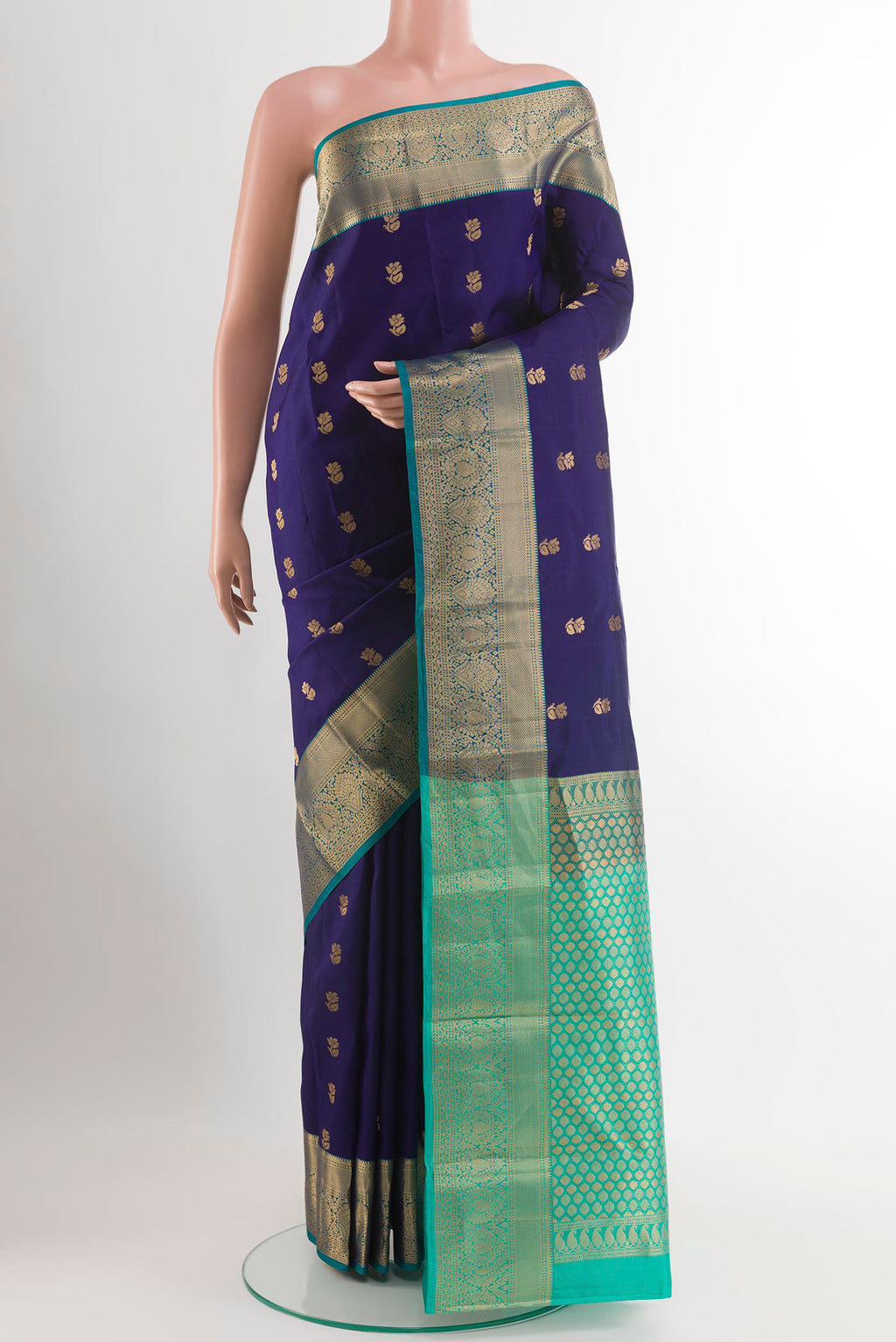 Dark Blue Kanjivaram Silk Saree with Zari Butta on the body and Zari Border.  displayed on a mannequin