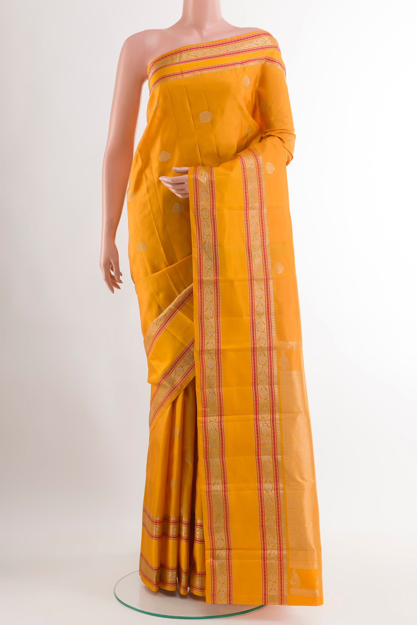 Yellow Dual Tone Kanchipuram Silk Saree with Zari Butta on the body and Zari Border.  displayed on a mannequin