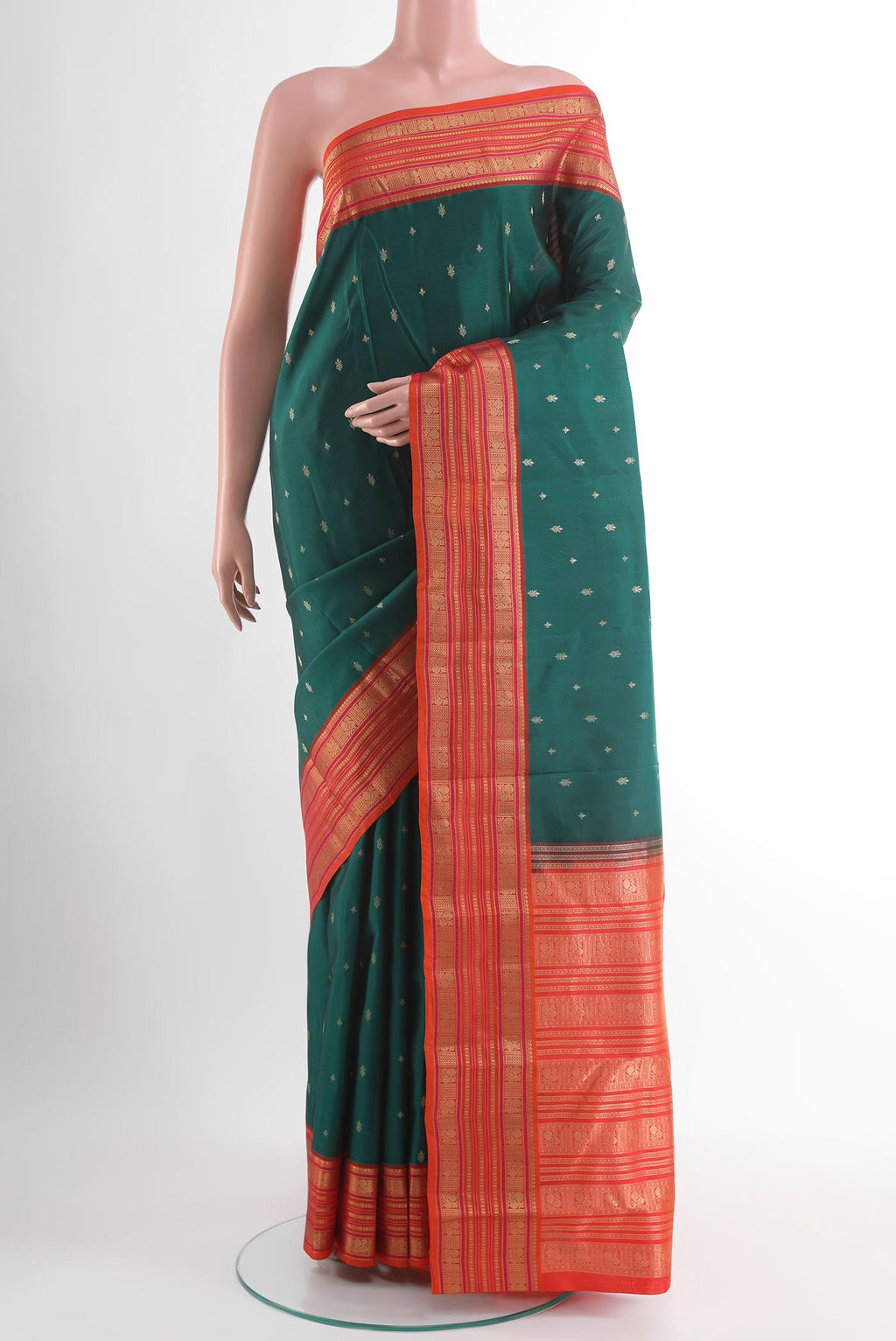 Green Kanjivaram Silk Saree with Zari Butta on the body and Zari Border.  displayed on a mannequin