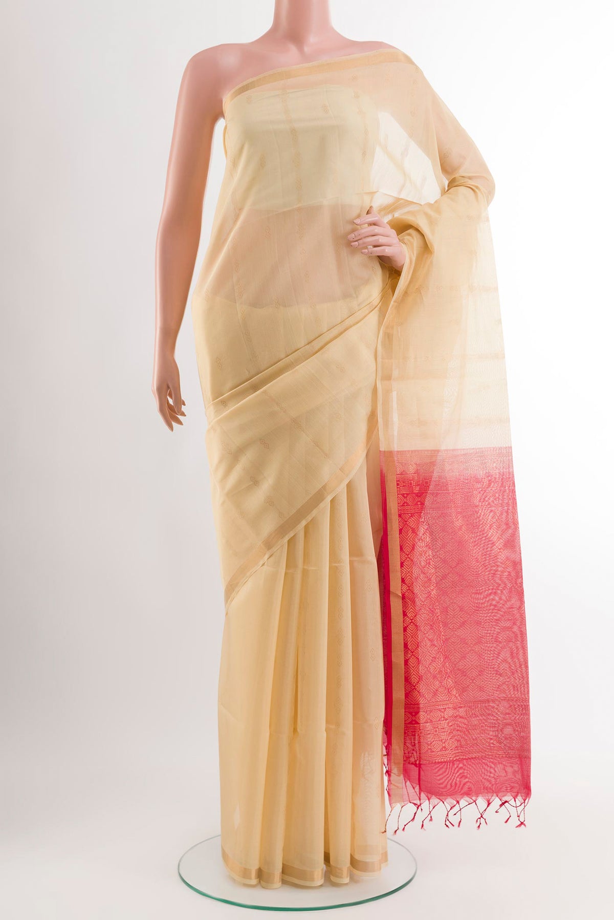 Cream Blended Kora Cotton Saree with Zari Butta on the body and Zari Border.  displayed on a mannequin