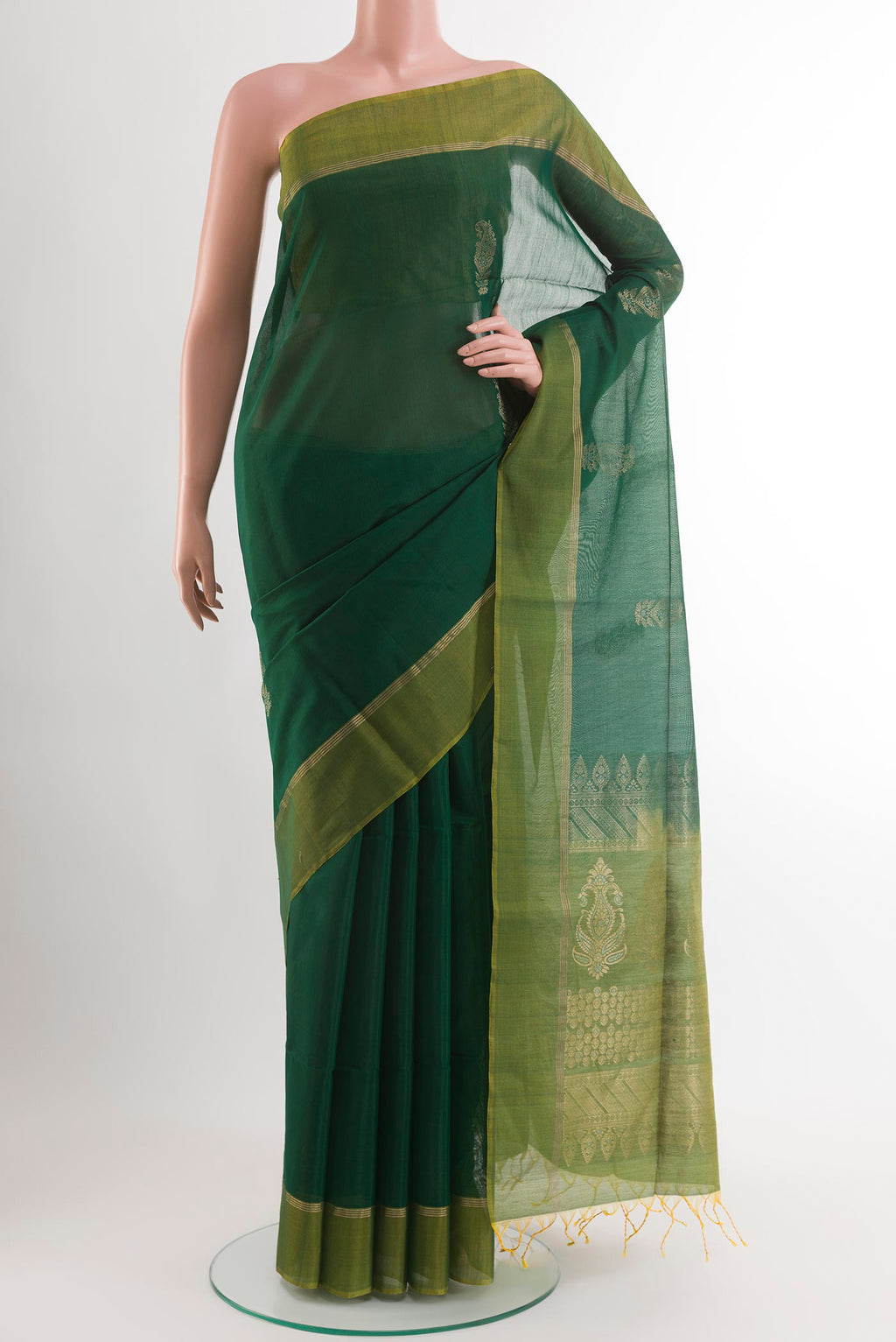Bottle Green Blended Kora Cotton Saree with Zari Butta on the body and Zari Border.  displayed on a mannequin
