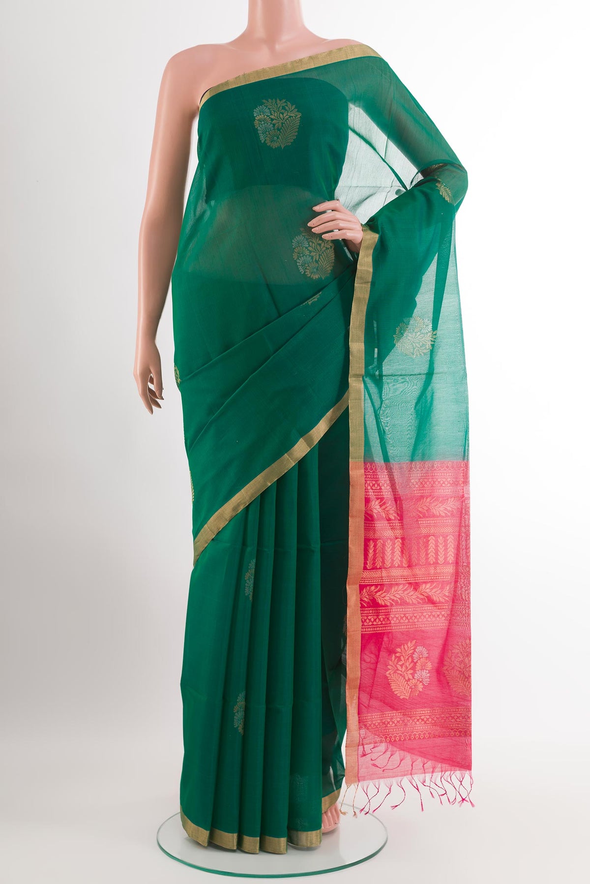 Green Blended Kora Cotton Saree with Zari Butta on the body and Zari Border.  displayed on a mannequin