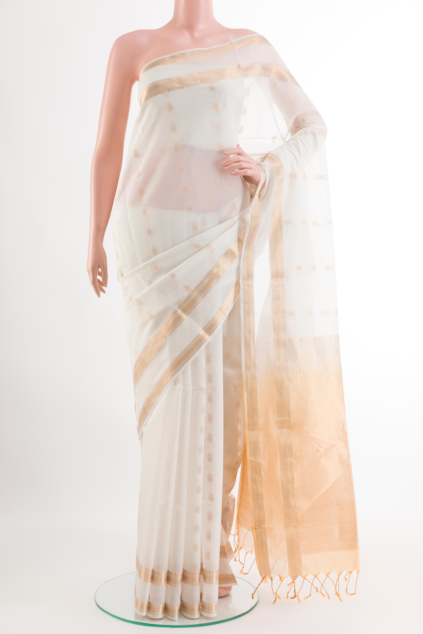Off White Blended Kora Cotton Saree with Zari Butta on the body and Zari Border.  displayed on a mannequin