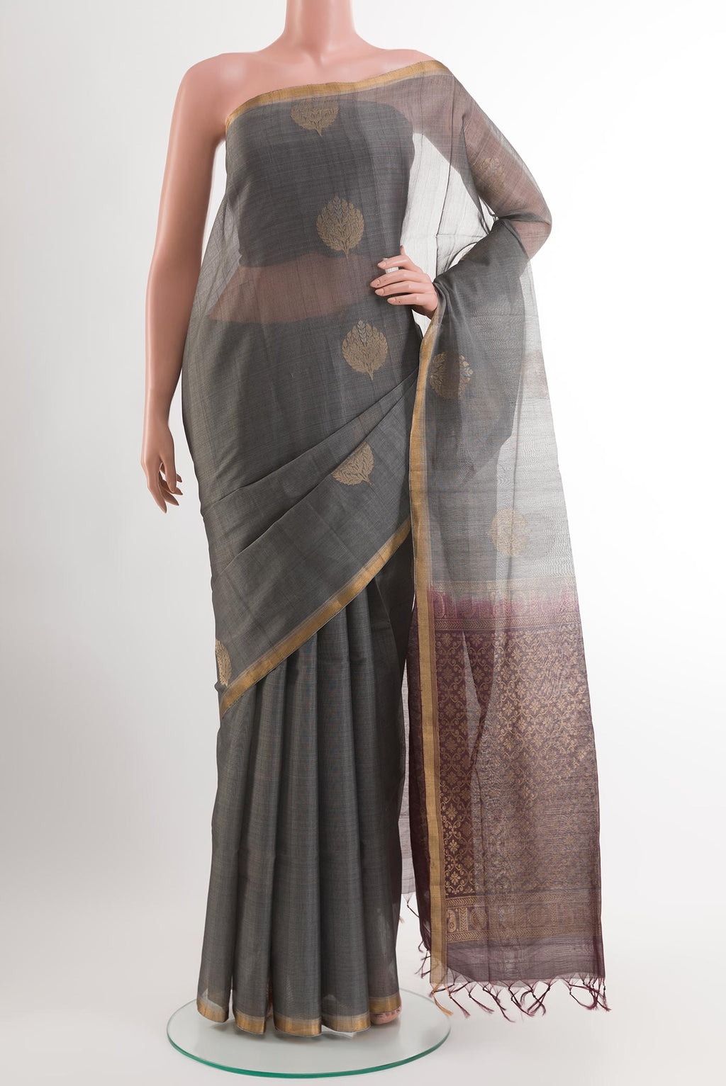 Grey Blended Kora Cotton Saree with Zari Butta on the body and Zari Border.  displayed on a mannequin