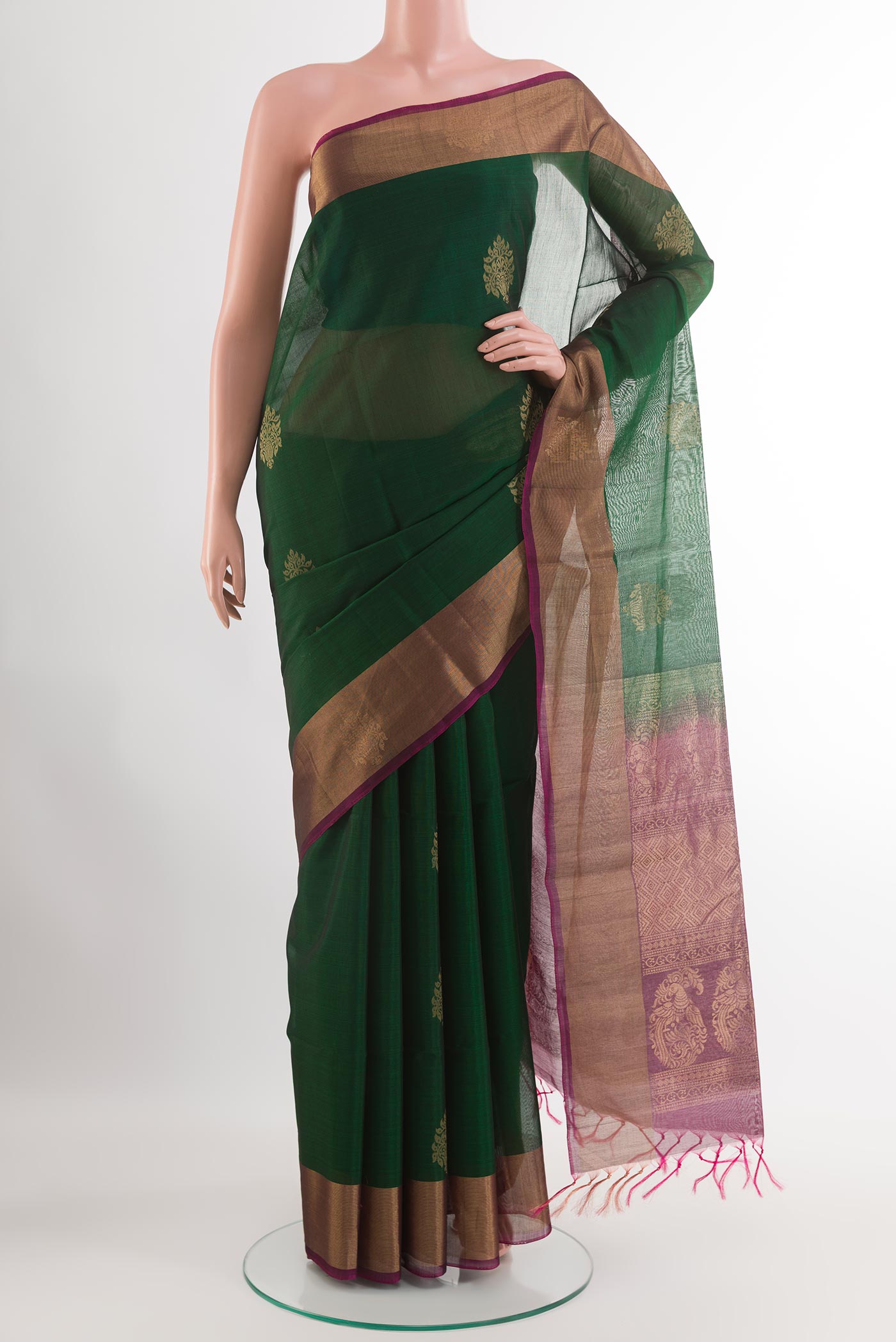 Bottle Green Blended Kora Cotton Saree with Zari Butta on the body and Zari Border.  displayed on a mannequin