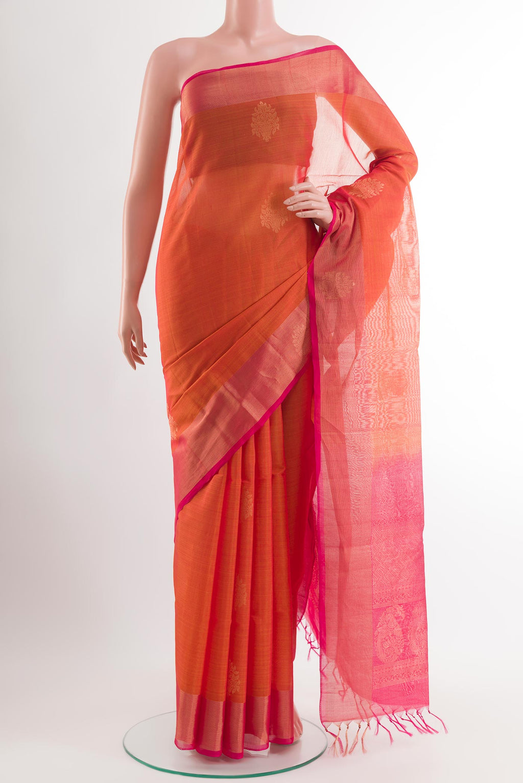 Orange Blended Kora Cotton Saree with Zari Butta on the body and Zari Border.  displayed on a mannequin