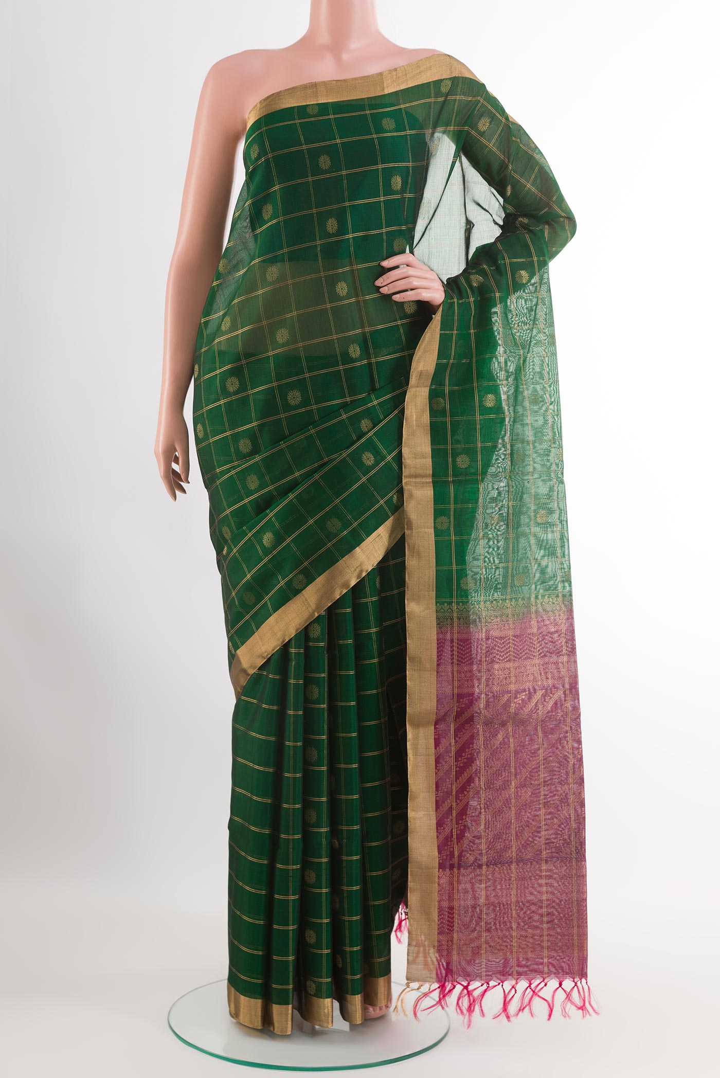 Bottle Green Blended Kora Cotton Saree with Zari Butta on the body and Zari Border.  displayed on a mannequin
