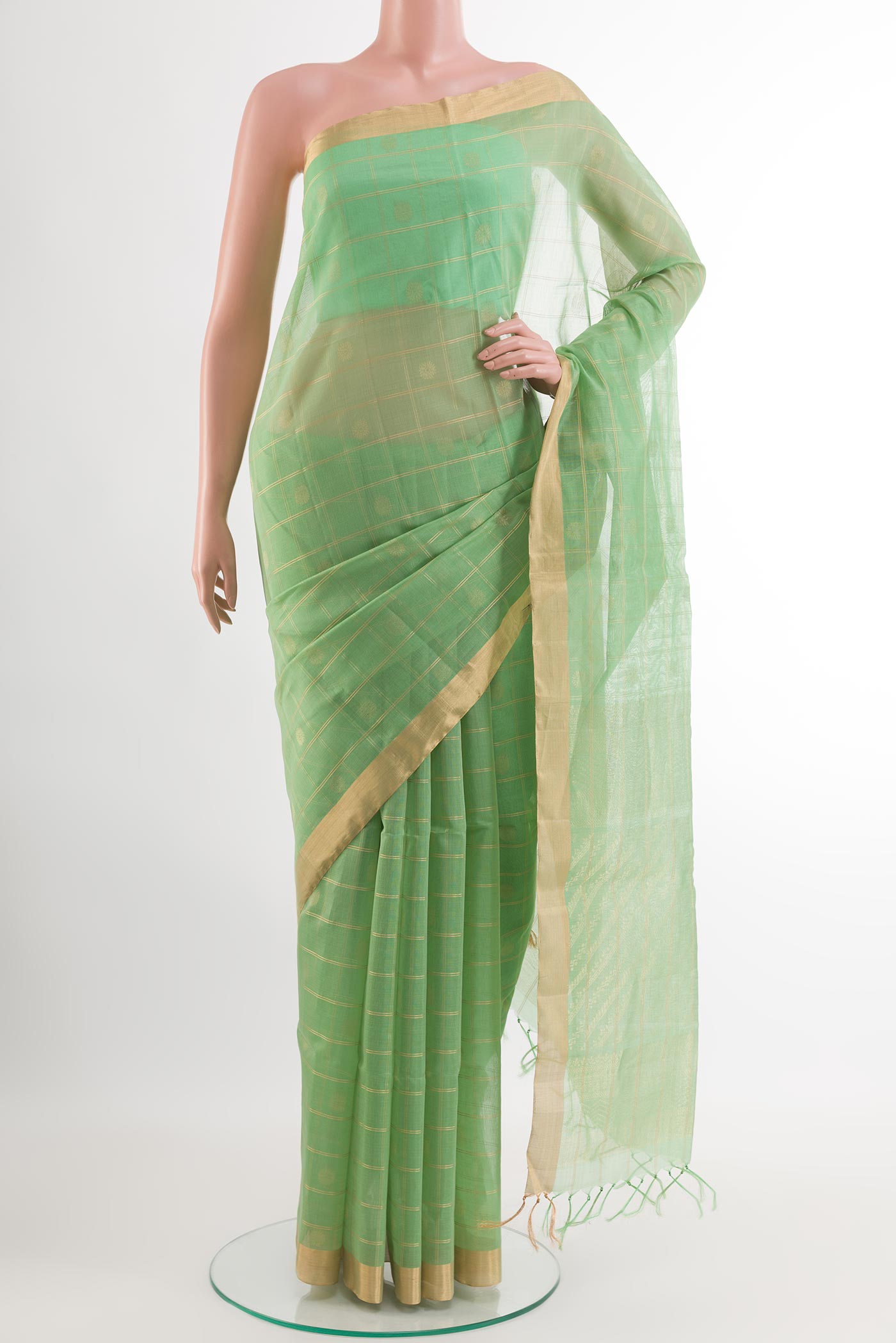 Green Blended Kora Cotton Saree with Zari Butta on the body and Zari Border.  displayed on a mannequin