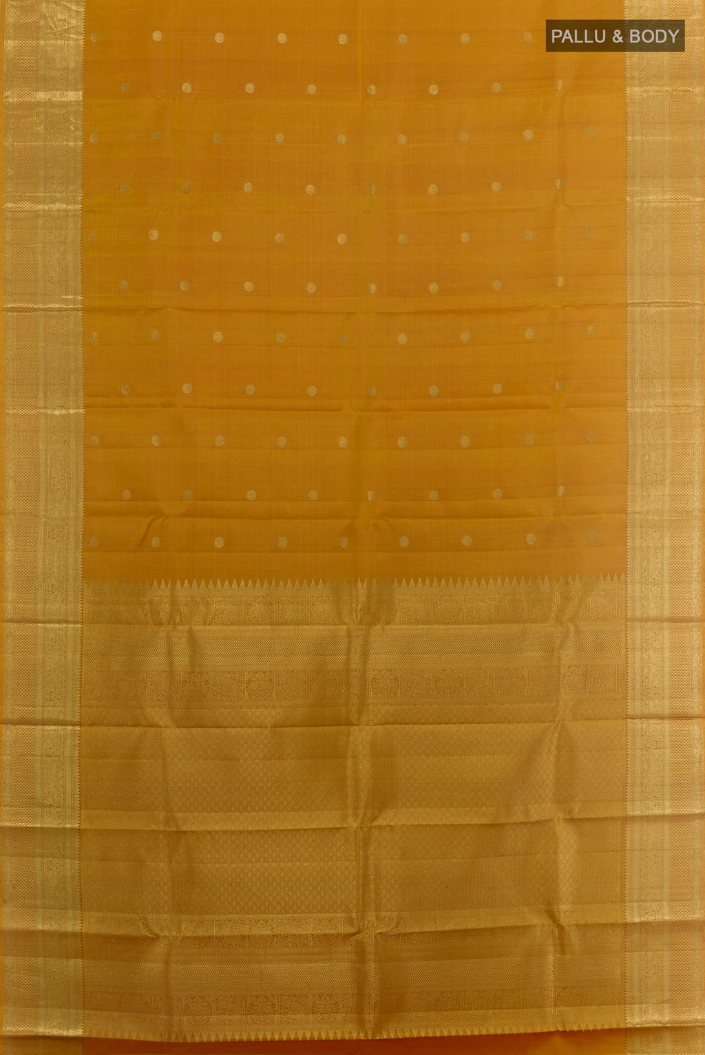 Flat view of Mustard Kanchipuram Silk Saree with Zari Butta on the body and Zari Border. 