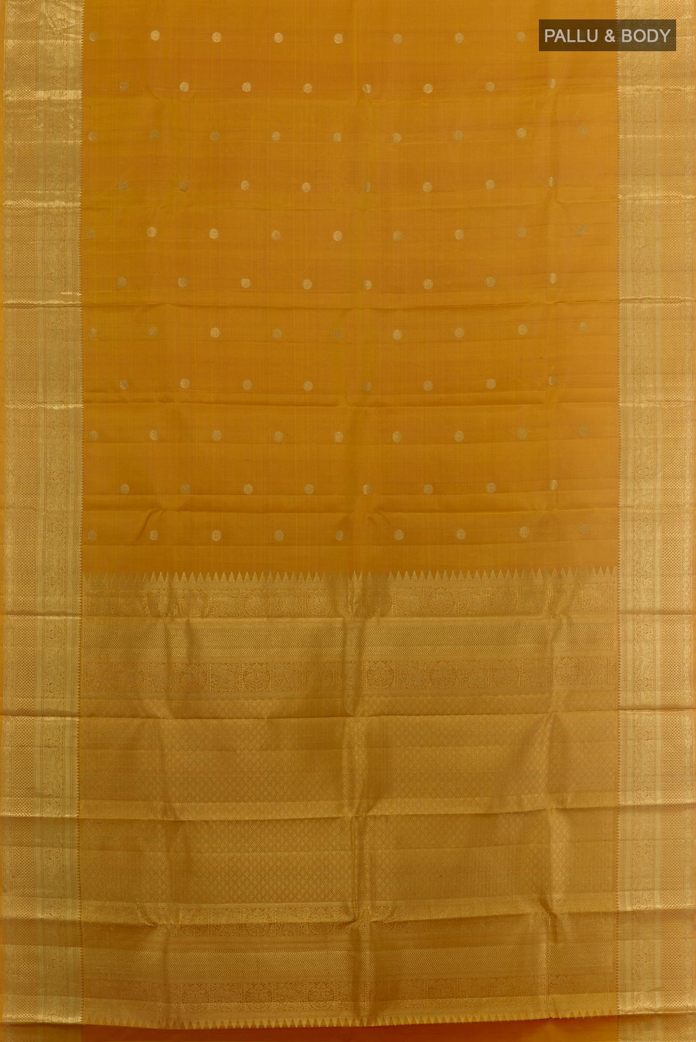 Flat view of Mustard Kanchipuram Silk Saree with Zari Butta on the body and Zari Border. 