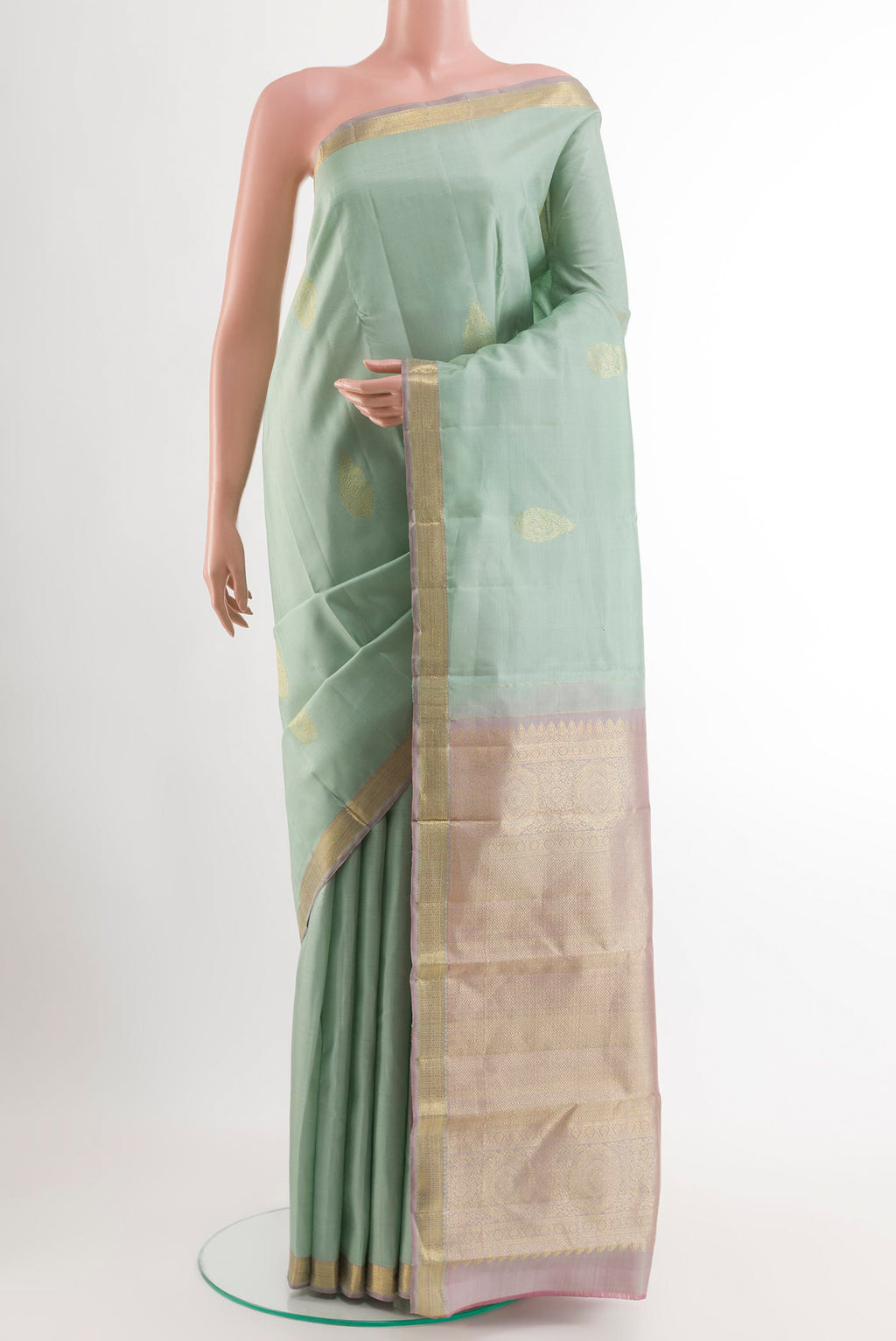 Sage Green Kanchipuram Silk Saree with Zari Butta on the body and Zari Border.  displayed on a mannequin