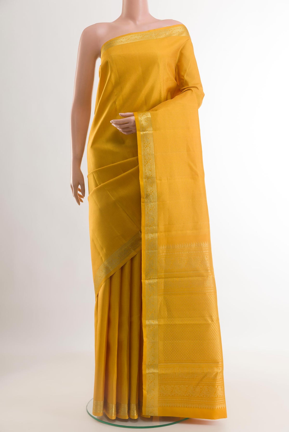 Yellow Kanchipuram Silk Saree with Zari Butta on the body and Zari Border.  displayed on a mannequin