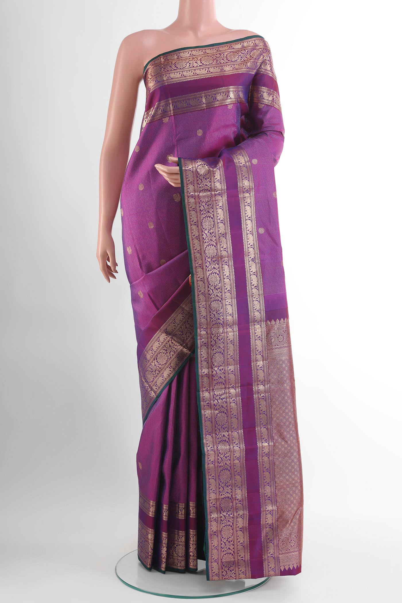 Purple Kanjivaram Silk Saree with Zari Butta on the body and Zari Border.  displayed on a mannequin