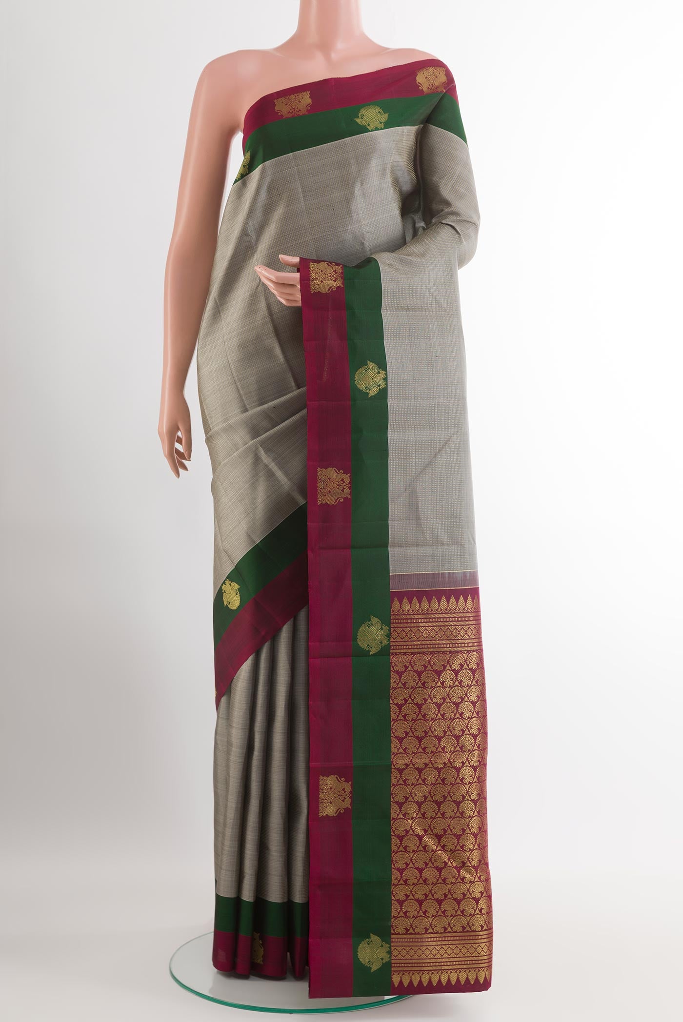 Grey Kanjivaram Silk Saree with Zari Brocade on the body and Zari Border.  displayed on a mannequin