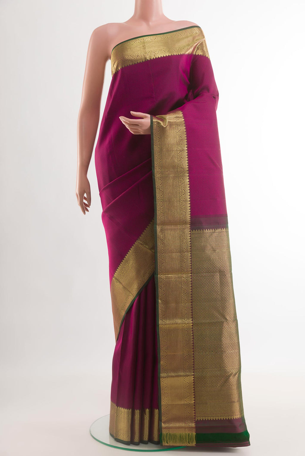 Magenta Kanjivaram Silk Saree with Jacquard design on the body and Zari Border.  displayed on a mannequin