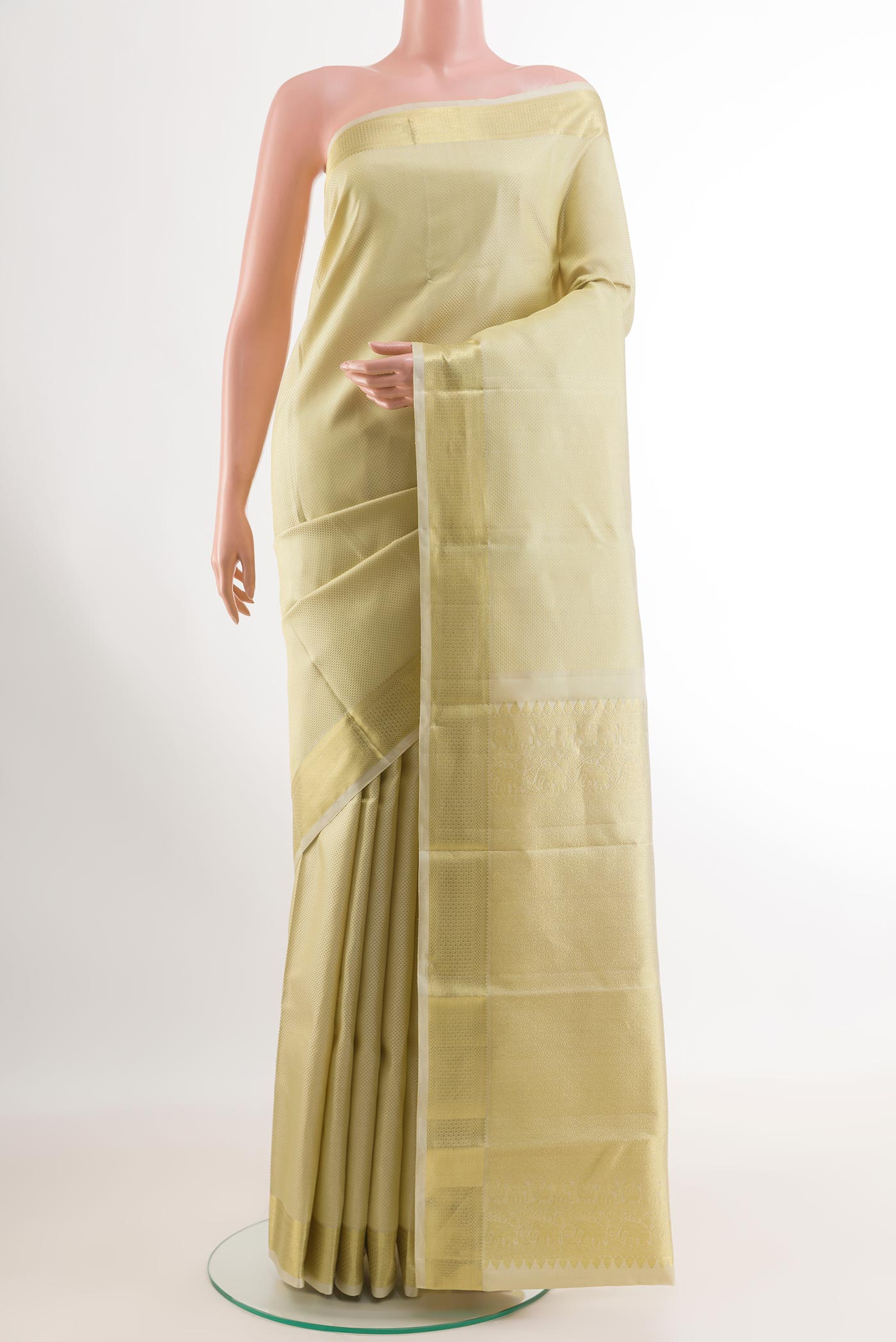 Off White Kanjivaram Silk Saree with Zari Brocade on the body and Zari Border.  displayed on a mannequin