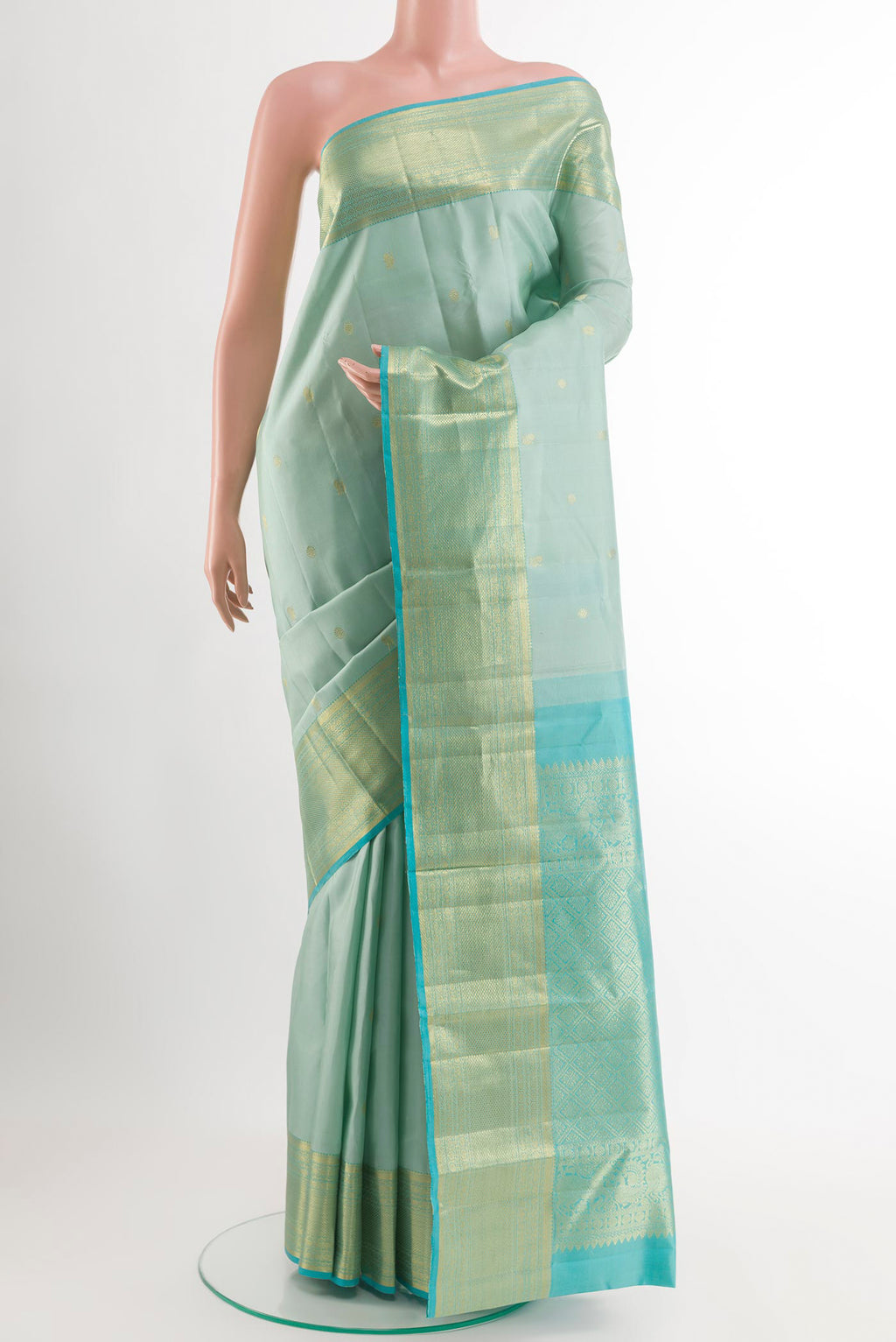 Sky Blue Kanchipuram Silk Saree with Zari Butta on the body and Zari Border.  displayed on a mannequin