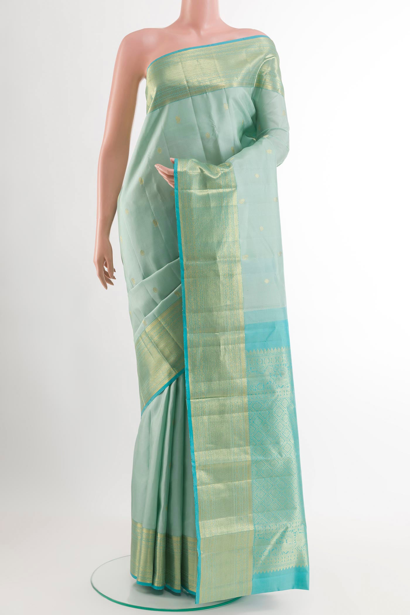Sky Blue Kanchipuram Silk Saree with Zari Butta on the body and Zari Border.  displayed on a mannequin