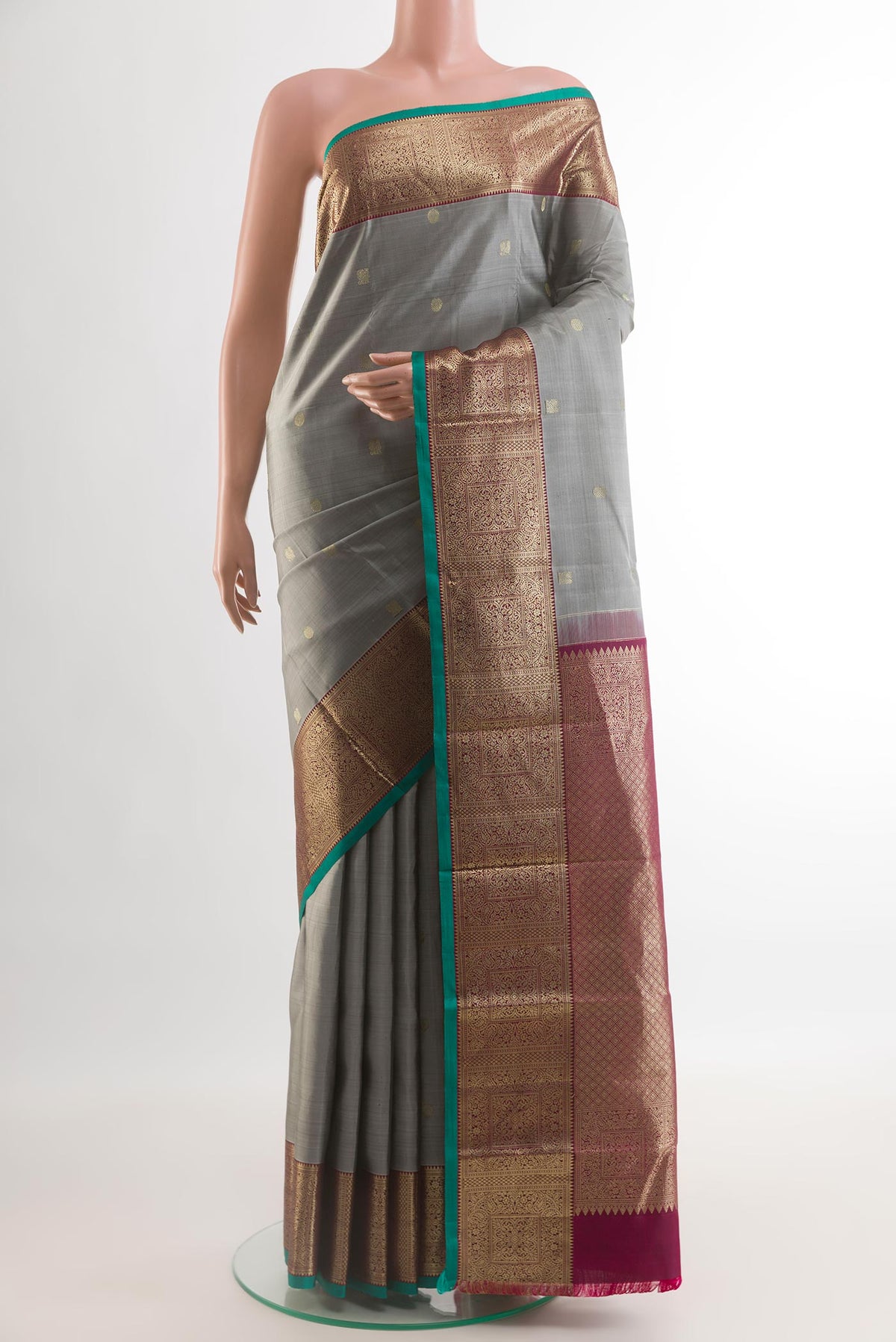 Grey Kanchipuram Silk Saree with Zari Butta on the body and Zari Border.  displayed on a mannequin
