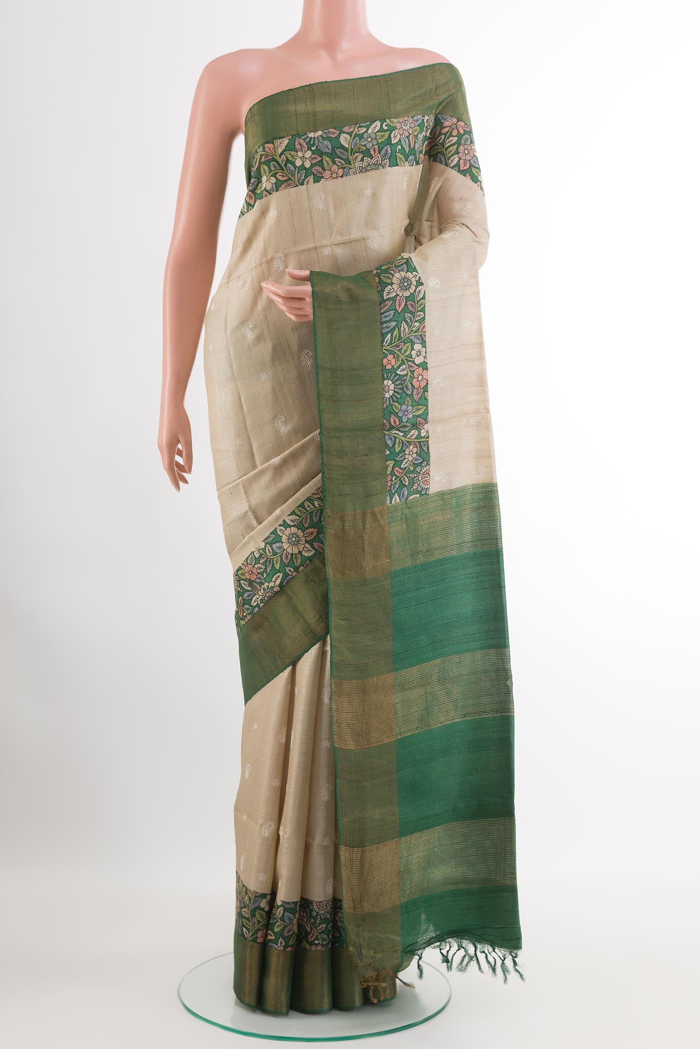 Off White Tussar Saree with Thread Butta on the body and Zari Border.  displayed on a mannequin
