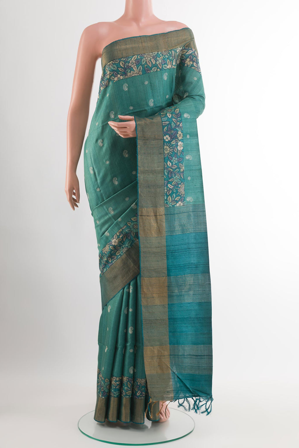 Light Blue Tussar Saree with Thread Butta on the body and Zari Border.  displayed on a mannequin