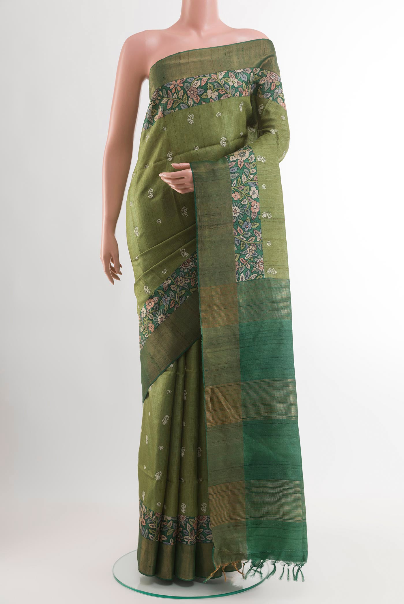 Green Tussar Saree with Zari Butta on the body and Zari Border.  displayed on a mannequin