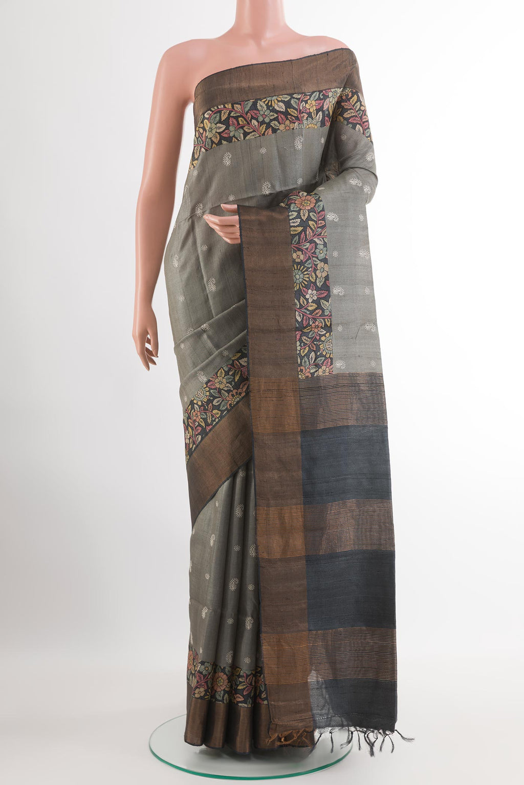 Grey Tussar Saree with Thread Butta on the body and Zari Border.  displayed on a mannequin