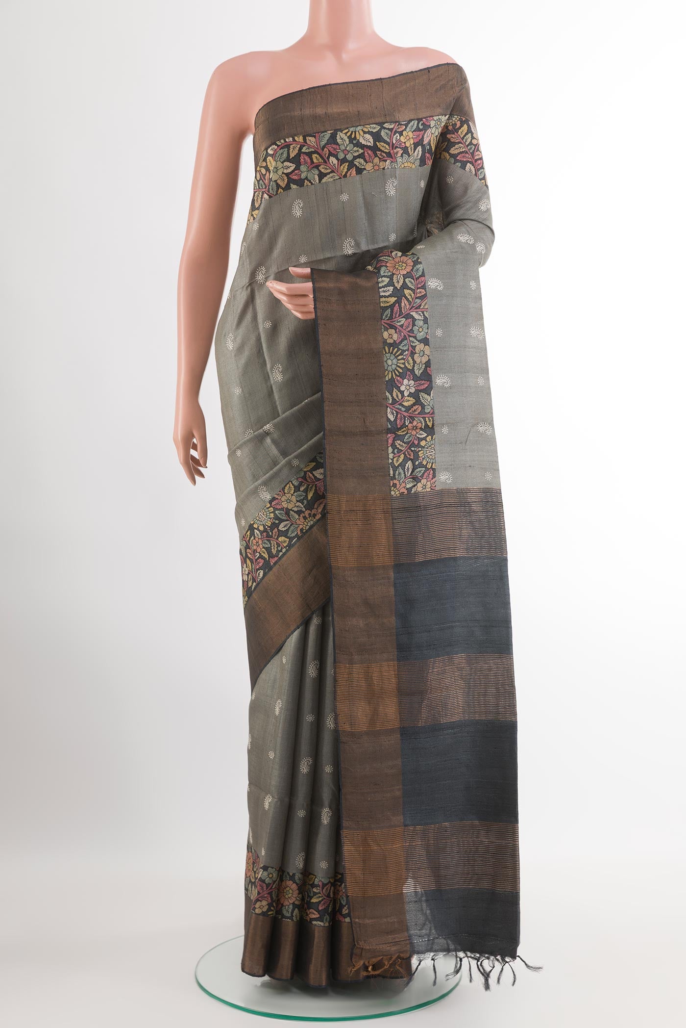 Grey Tussar Saree with Thread Butta on the body and Zari Border.  displayed on a mannequin