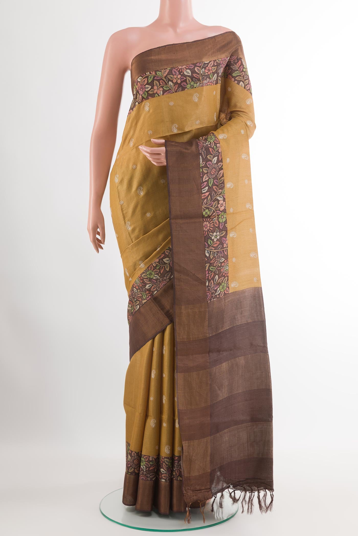 Mustard Tussar Saree with Thread Butta on the body and Zari Border.  displayed on a mannequin