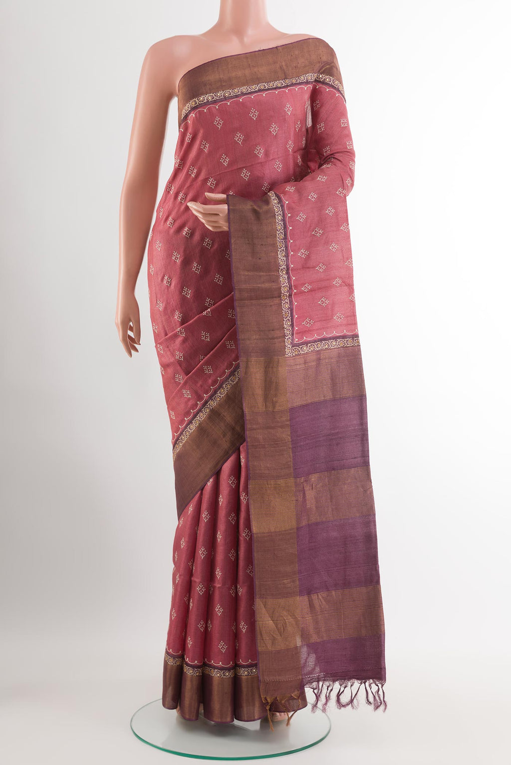 Light Magenta Tussar Saree with Thread Butta on the body and Zari Border.  displayed on a mannequin