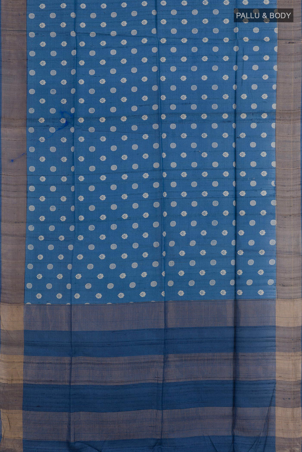 Flat view of Blue Tussar Saree with Printed design on the body and Zari Border. 