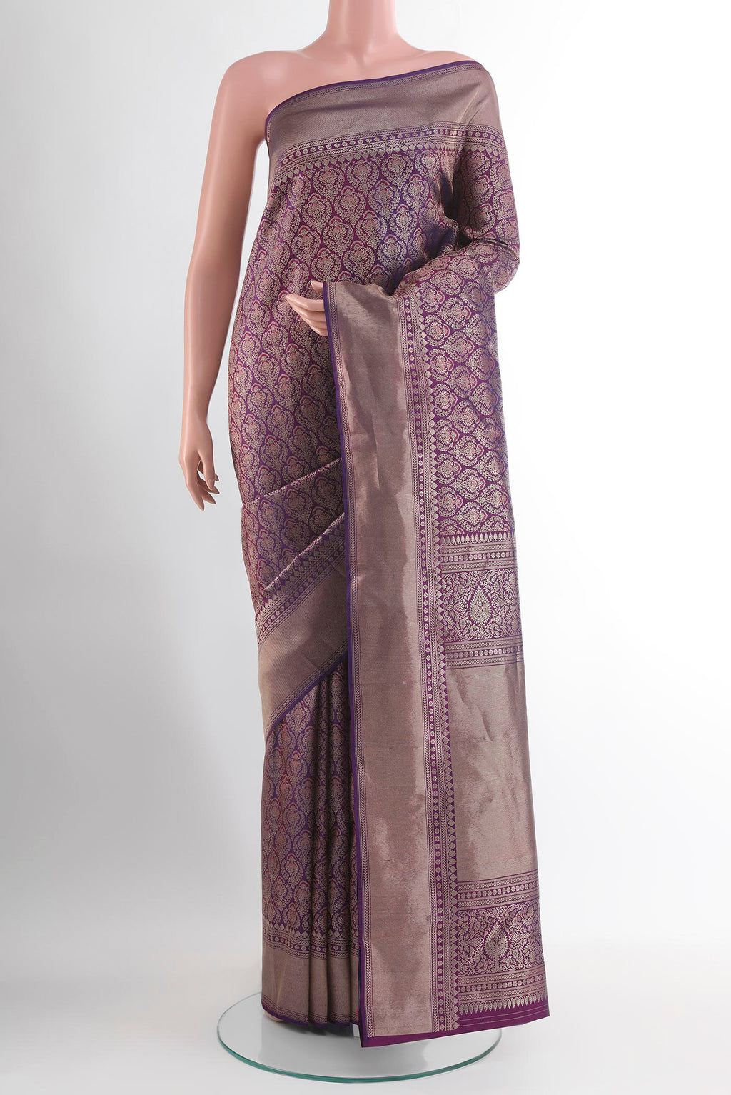 Purple Kanchipuram Silk Saree with Zari Butta on the body and Zari Border.  displayed on a mannequin