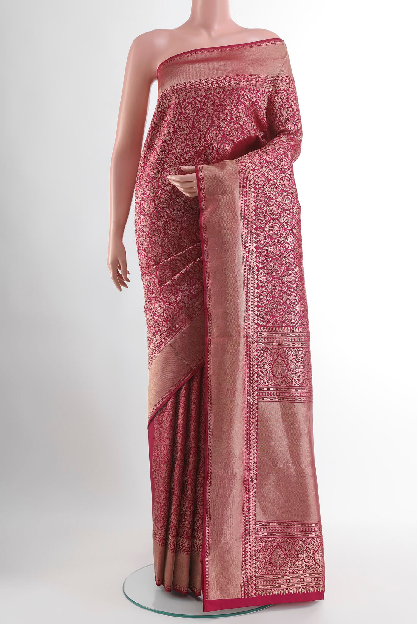 Rani Pink Kanchipuram Silk Saree with Zari Butta on the body and Zari Border.  displayed on a mannequin