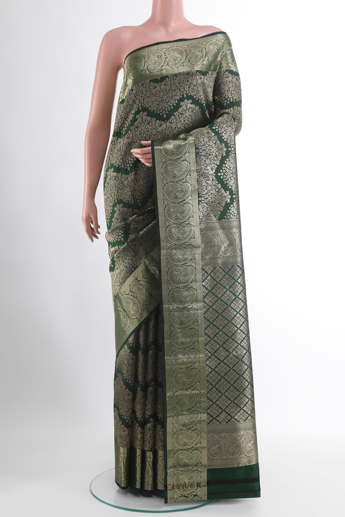 Green Kanjivaram Silk Saree with Zari Butta on the body and Zari Border.  displayed on a mannequin