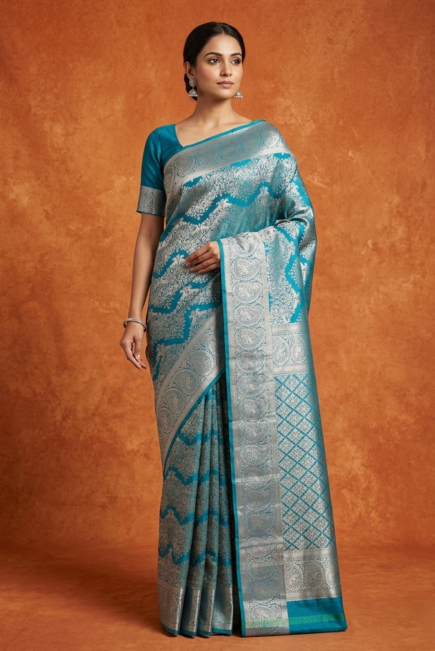 Model wearing a Blue Kanchipuram Silk Saree with Zari Brocade on the body and Zari Border.